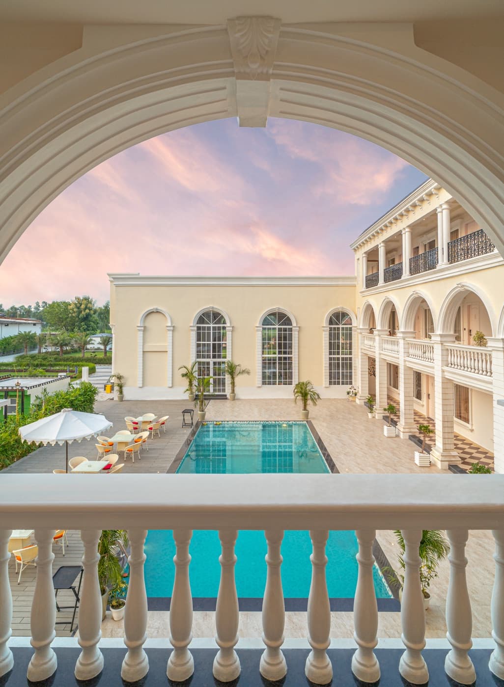 Poolside view framed by a grand archway