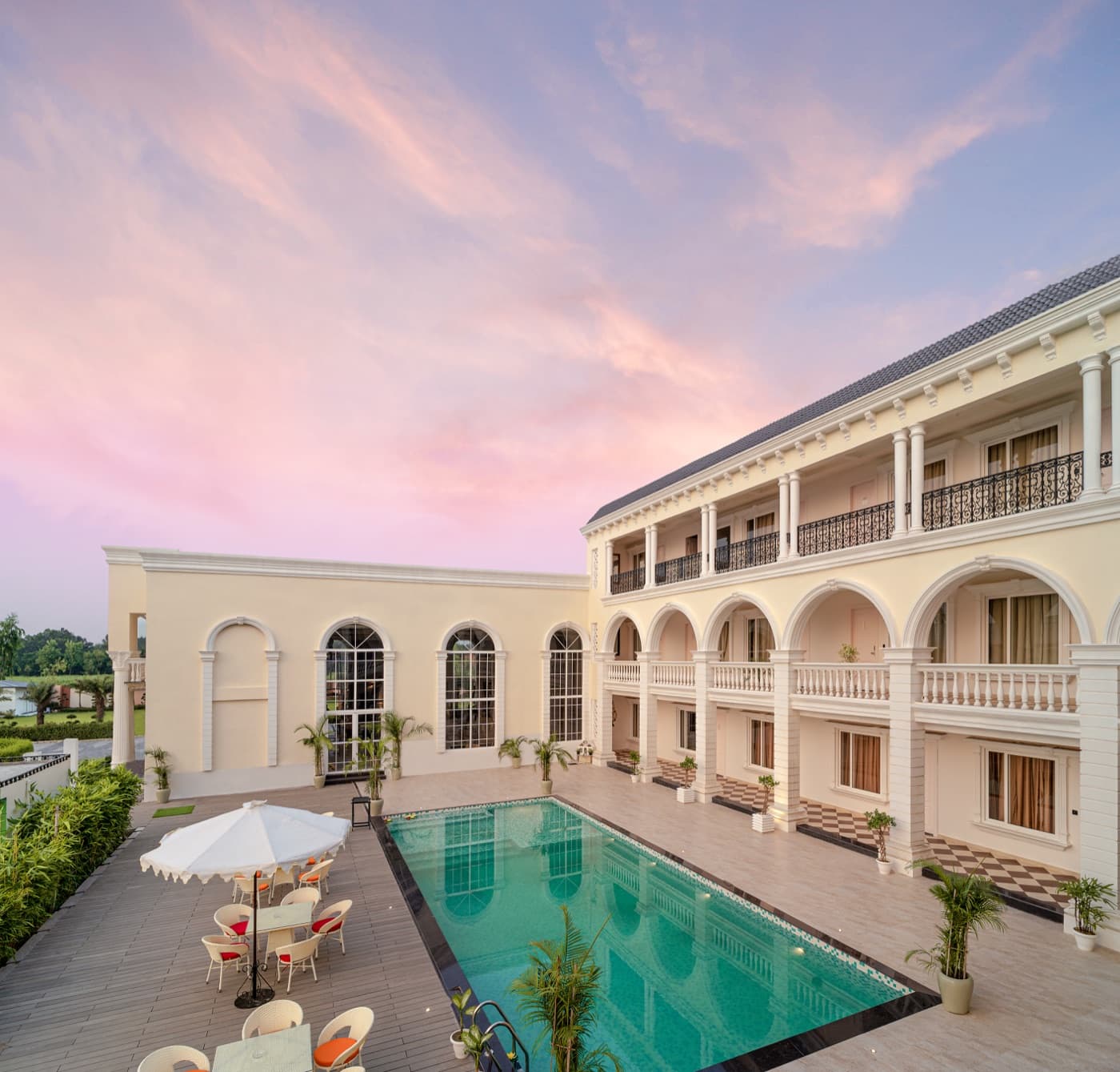 Aerial view of the resort and pool deck at dusk